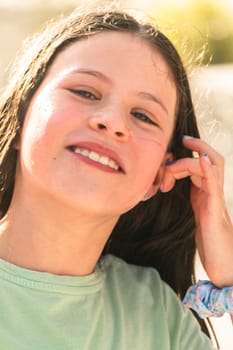 A joyful young girl gleefully gets soaked in refreshing water mist during a hot summer day.