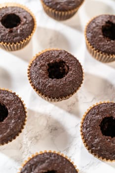 Each chocolate cupcake receives a generous filling of luscious caramel, adding an extra layer of flavor and indulgence.