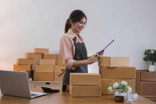 Startup small business entrepreneur SME, asian woman receive order on phone. Success young Asian small business owner home office, online sell marketing delivery.