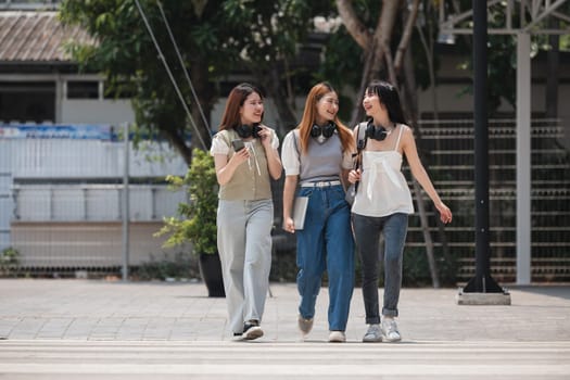 Group of happy students walking along the corridor at college.