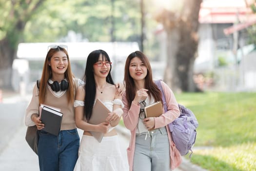 Group of Young Asian student walking and talking at university before class room. education, back to school concept.