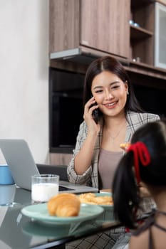 Working mom work from home office. businesswoman and cute child using laptop work freelancer workplace in home, Lifestyle family moment.