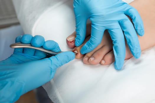 Young woman getting medical pedicure in beauty salon, close up.