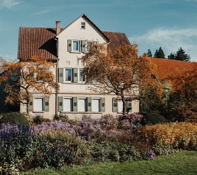 House with nice garden in fall. Flowers in the Park. Bietigheim-Bissingen. Germany, Europe. Autumn Park and house, nobody, bush and grenery