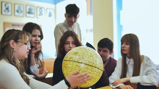 High school students looking at the yellow globe of the moon
