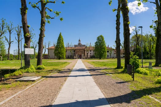 Exterior of Certosa di Pavia monastery, historical monumental complex that includes a monastery and a sanctuary. green court and a church.,Pavia,Italy.