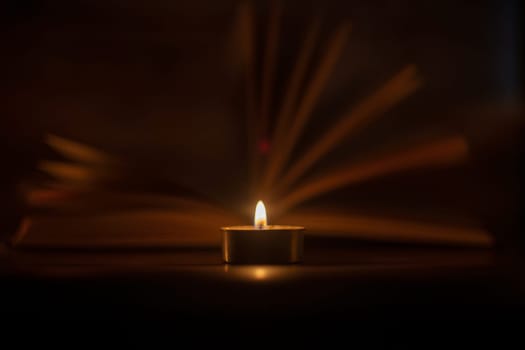 The Book in the candlelight. High quality photo