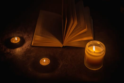 The Book in the candlelight. High quality photo