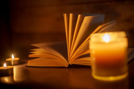 The Book in the candlelight. High quality photo