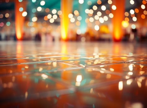 Shiny tiled floor with orange pillars and blurred lights in the background