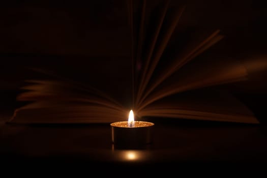 The Book in the candlelight. High quality photo