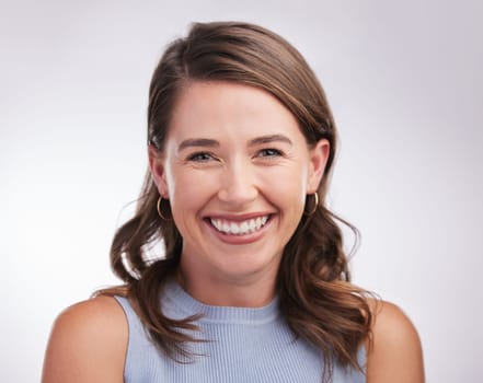 Laughing, woman and portrait in white studio background for skincare, glow and cosmetics or confidence. Happy, female person and smile or joyful for dermatology results, treatment and wellness.