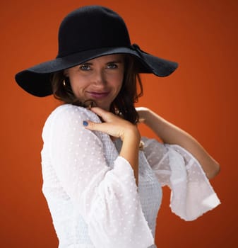 Woman, studio and hat with portrait for fashion with trendy, cool and summer outfit for vacation style inspiration. Designer, brown background and trends with glamour for clothing with pride.