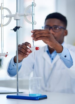 Science, burette clamp and scientist in laboratory with beaker for chemical research with liquid. Innovation, chemistry and man researcher measuring fluid with biotechnology equipment for medical.