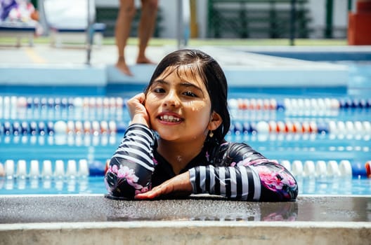 Portrait of a smiling girl in the pool
