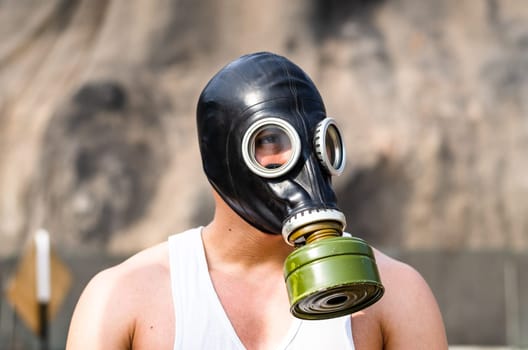 A muscular man in a gas mask. Pademic concept