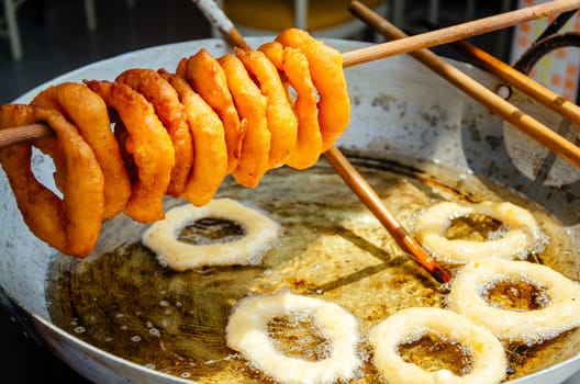 Traditional peruvian Dessert: Picarones Made whit Sweet potato and wheat flour. fried an served whit honey figs.