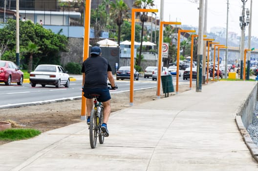 A cyclist riding his bike on the sidewalk, concept of sport life, healthy life