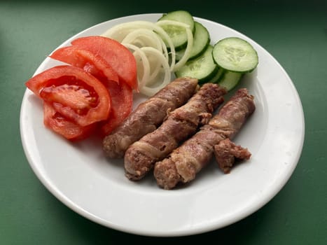 Cooking cevapchichi the Balkan meat sausages