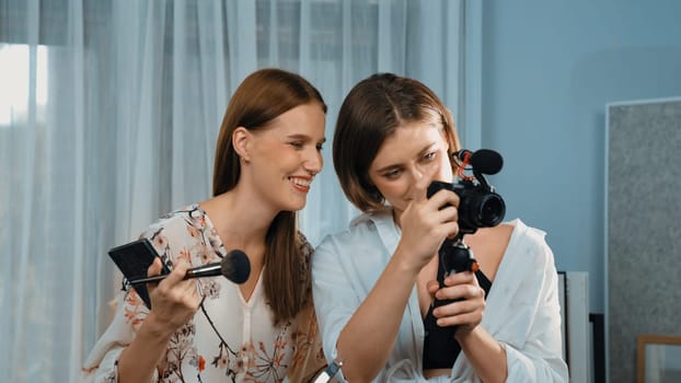Two influencer partner shoot live streaming vlog video review makeup prim social media or blog. Happy young girl with cosmetics studio lighting for marketing recording session broadcasting online.