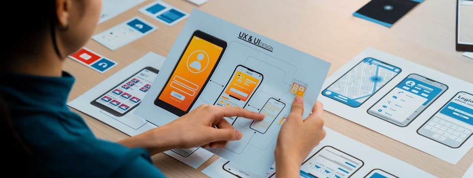 Panorama banner of startup company employee planning on user interface prototype for mobile application or website in office. UX UI designer brainstorm user friendly interface plan. Synergic