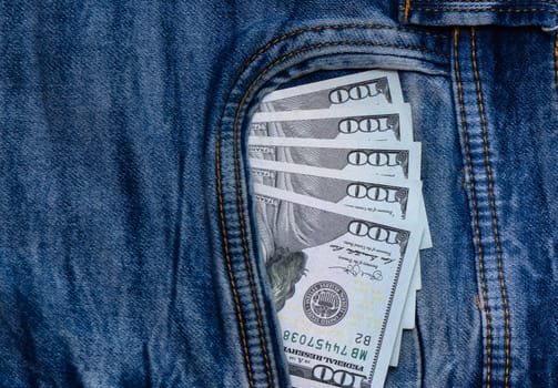 dollars bills lies in jeans pocket.money in wallet.savings.cash.international currency.