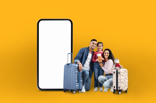 A cheerful arab family with suitcases next to a large phone screen, representing family vacation applications and online offers in a digital isolated manner