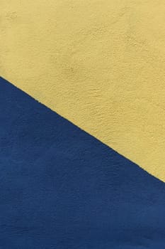 Colored paper in blue and yellow, divided in half, diagonally background 1