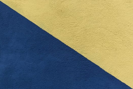 Colored paper in blue and yellow, divided in half, diagonally background
