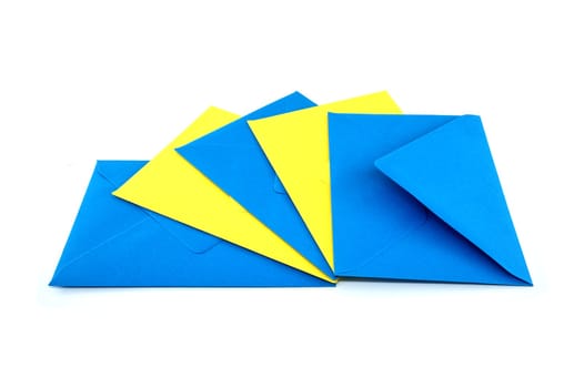 Collection of blue and yellow paper envelopes arranged against a white background