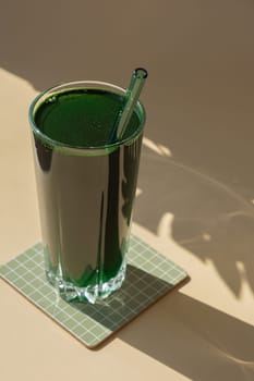 Organic blue-green algae spirulina detox drink in glass powder food. Health protein cocktail smoothie of chlorella. Vitamins and minerals to diet. Prebiotic and antioxidant rich Dietary supplement Seaweed superfood concept