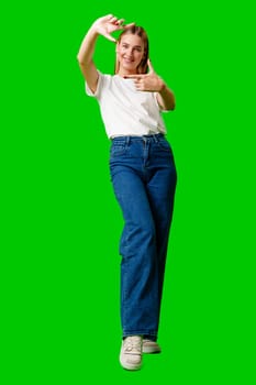 Woman Making a Frame Gesture With Her Hands on green background