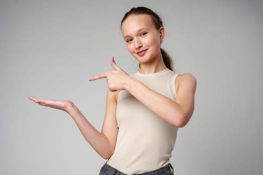 Woman in White Top Pointing at Something in studio