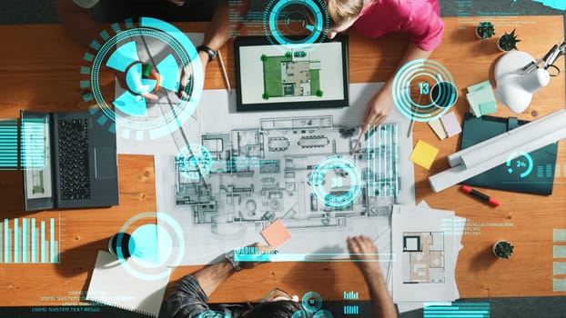 Top down view of engineer planning and writing at blueprint. Architect team working together to design building construction while sitting at meeting table with financial chart holographic. Symposium.