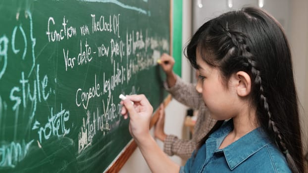 Skilled asian girl writing engineering prompt and programing system while standing blackboard with generated AI prompt written by diverse smart student at STEM technology lesson. Education. Pedagogy.