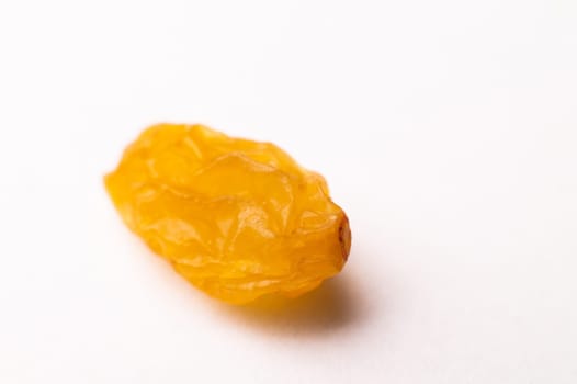 macro photography of raisins on a white background, side view. close-up of one piece of raisin.