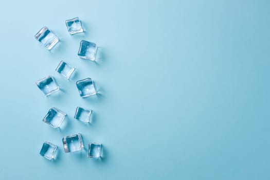 top view of ice cubes of different sizes on blue background