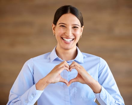 Heart, happy and business woman portrait with emoji and love hand sign in office with smile. Professional, young employee and company consultant with romance gesture for valentines day at a job.