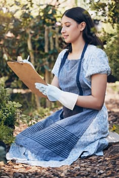 Checklist, gardening and woman checking flowers for botany, growth or development in nature. Botanist, sustainable and female florist with clipboard for floral plants in eco friendly environment