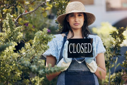 Sad, woman and sign for closed business of florist, nursery and depression from debt or fail. Startup, stress and entrepreneur with announcement of bankrupt economy, problem and closing boutique.