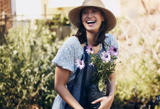 Flowers, gardening and woman with plant in outdoor for environment, sustainability or ecology. Nature, laughing and happy female person for green nursery, agriculture or landscaping in backyard.