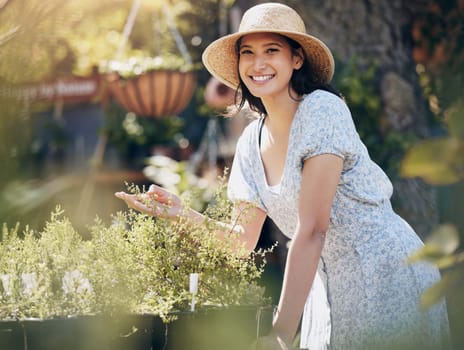 Smile, portrait and woman with plants at garden in nature to check growth, ecology and sustainable in spring. Happy, nursery or florist in hat with organic flowers or leaf at small business in Brazil.