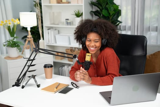 Host channel of beautiful African woman talking in online broadcast teaching marketing influencer, with listeners in broadcast or online. Concept of anywhere at work place. Tastemaker.