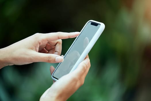 Mockup, smartphone and hand of person in park for social media, communication or browsing internet. Online, scrolling and closeup of woman on mobile phone for promotion, copy space or branding.