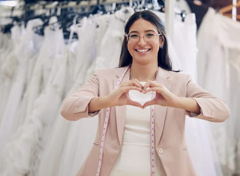 Heart hands, portrait and wedding dress and fashion designer woman in studio for love of career. Emoji, feedback or hand gesture and happy seamstress or tailor in design workshop with tape measure.
