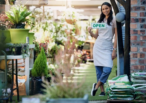 Woman, portrait and open sign at nursery with small business, gardening and sustainability with welcome. Poster, notice and entrance with flower seller in retail, florist or entrepreneur with service.