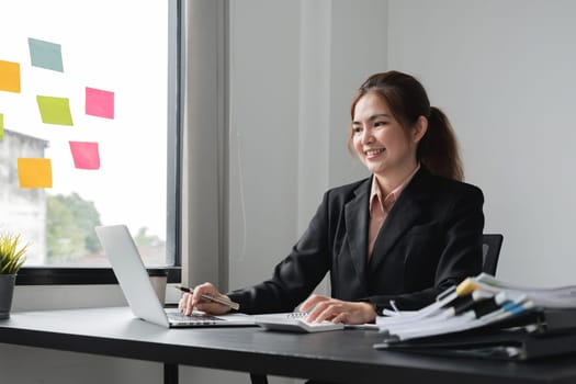 Accounting planning budget concept : Business woman offices working for arranging documents unfinished stack of document papers with pen.