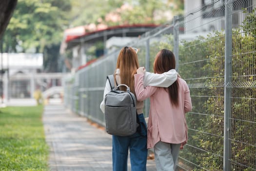 Group of young Asian college students are studying together in university. Students outdoors. Education concept..