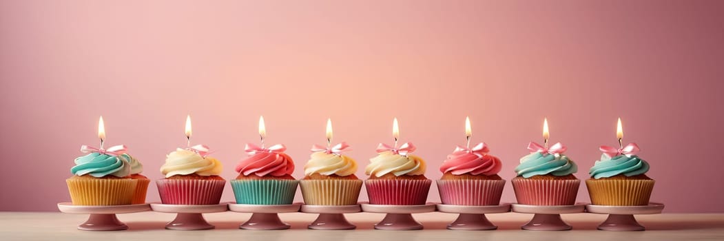 Colorful cupcakes with lit candles are displayed against a pink background, indicating an indoor celebration event marking of joy and celebrating. with free space.