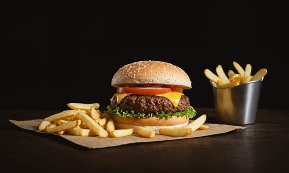 Commercial photo of a delicious hamburger with crispy chips on the side.